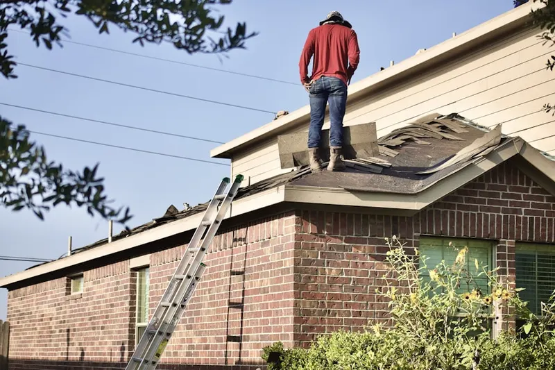 Professional roofer working on a residential roof in Crandall